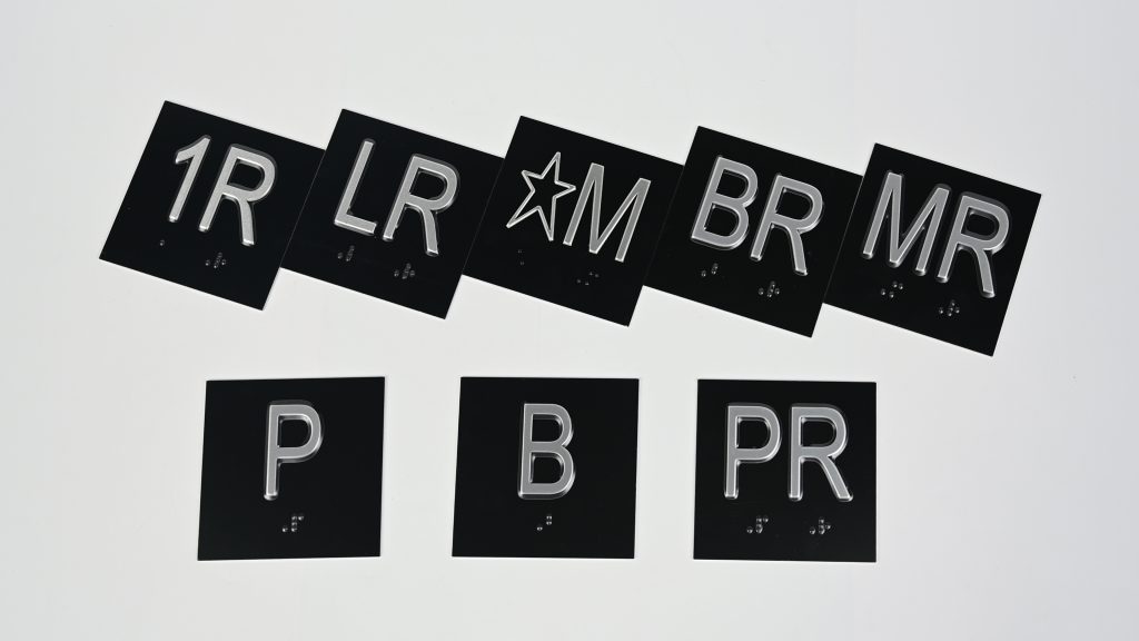 Brushed aluminum write-on zone on elevator nameplate