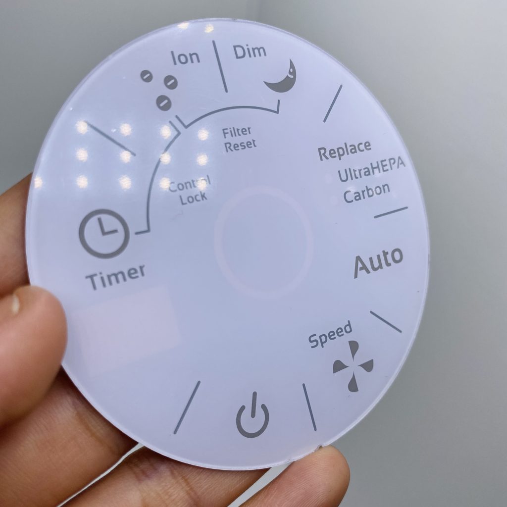 Circular frosted graphic overlay for air purifier control panel with translucent backlit icons