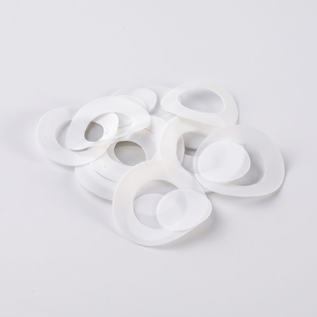 three flat white ptfe teflon flange gaskets on brand background bx panel