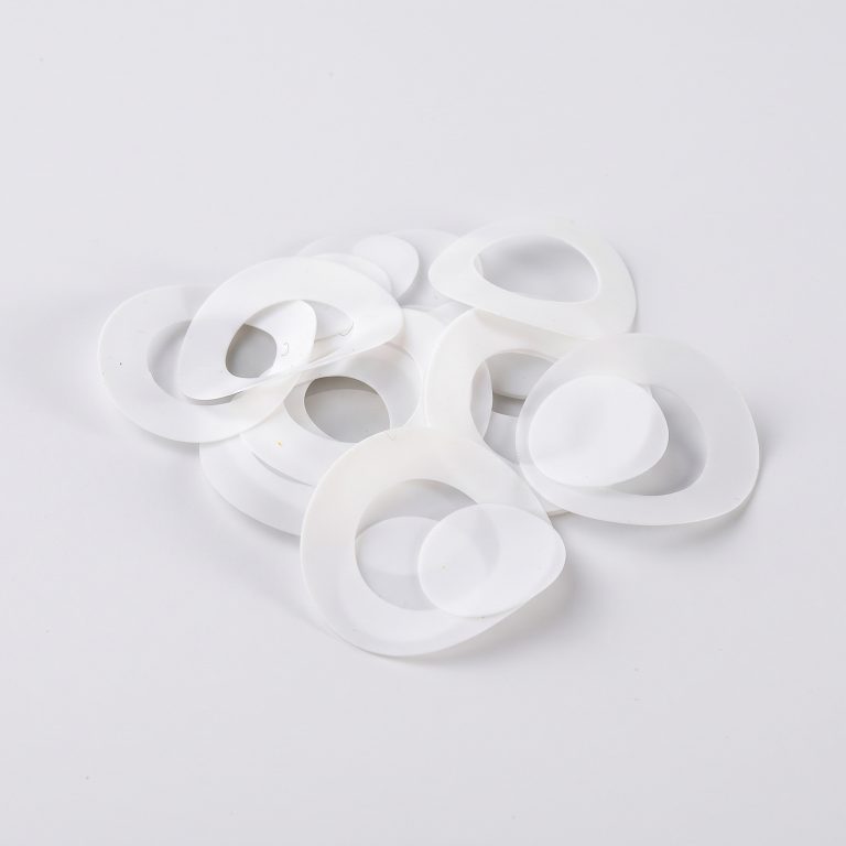 three flat white ptfe teflon flange gaskets on brand background bx panel